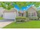 Charming home featuring manicured lawn, lush shrubs, and a welcoming two-car garage at 6000 Isabel Ct., Myrtle Beach, SC 29579
