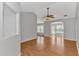 Sunlit living room showcasing hardwood floors, a ceiling fan, and multiple windows at 6000 Isabel Ct., Myrtle Beach, SC 29579