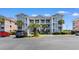 A bright, multi-story condo building with classic white pillars and lush palms in a well-maintained community at 608 Waterway Village Blvd. # 27-F, Myrtle Beach, SC 29579