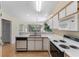 Well-lit kitchen offers ample counter space, a breakfast bar, and a view into the spacious living area at 608 Waterway Village Blvd. # 27-F, Myrtle Beach, SC 29579