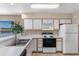 Functional kitchen has ample counter space, white cabinets, and a window with a water view at 608 Waterway Village Blvd. # 27-F, Myrtle Beach, SC 29579