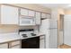 Compact kitchen with white appliances and cabinetry, alongside a convenient laundry area at 608 Waterway Village Blvd. # 27-F, Myrtle Beach, SC 29579
