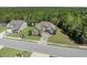 A beautiful home with manicured lawn, mature trees, and a long driveway in a peaceful neighborhood at 610 Cocas Dr., Myrtle Beach, SC 29579