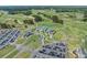 An aerial view of a clubhouse with a parking lot, putting green, and golf course at 610 Cocas Dr., Myrtle Beach, SC 29579