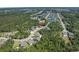 An aerial view of a quiet neighborhood with mature trees, a small pond and well-maintained lawns at 610 Cocas Dr., Myrtle Beach, SC 29579