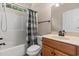 Bathroom with neutral tones, a combined tub and shower, and wood-stained cabinets at 610 Cocas Dr., Myrtle Beach, SC 29579