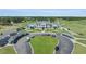 Aerial view of the clubhouse with beautiful landscaping and golf cart parking on a sunny day at 610 Cocas Dr., Myrtle Beach, SC 29579