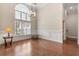 Dining room with hardwood floors, wainscoting, a chandelier, and a large arched window at 610 Cocas Dr., Myrtle Beach, SC 29579
