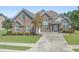 Charming brick home featuring a well-manicured front yard with lush greenery and a welcoming driveway at 610 Cocas Dr., Myrtle Beach, SC 29579