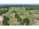A beautiful aerial view of the meticulously manicured golf course winding through lush greenery at 610 Cocas Dr., Myrtle Beach, SC 29579