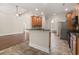 Open kitchen and living space with a breakfast bar, wood floors, and stainless steel refrigerator at 610 Cocas Dr., Myrtle Beach, SC 29579