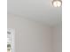 Bright bedroom features neutral walls, a window letting in natural light, and a classic ceiling light fixture at 625 Woodside Dr., Conway, SC 29526