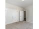 Bedroom featuring double doors to a closet and a doorway to another room, with carpeted flooring at 625 Woodside Dr., Conway, SC 29526