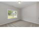 Bedroom with neutral color palette; large window provides natural light and neighborhood views at 625 Woodside Dr., Conway, SC 29526