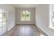 This dining area offers wood flooring, a chandelier, and windows with scenic views, creating a welcoming space at 625 Woodside Dr., Conway, SC 29526