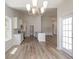Bright kitchen and dining area with lots of windows and a modern chandelier at 625 Woodside Dr., Conway, SC 29526