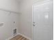 Compact laundry room with a utility sink hookup, overhead wire shelving and a white door to the exterior at 625 Woodside Dr., Conway, SC 29526