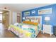 Bright bedroom with beach decor, colorful quilt, and access to balcony at 6804 N Ocean Blvd. # 523, Myrtle Beach, SC 29572