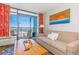 Comfortable living room with a sofa, coffee table, and sliding glass doors that lead to an ocean view at 6804 N Ocean Blvd. # 523, Myrtle Beach, SC 29572