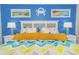 Comfortable main bedroom with colorful patterned bed linens, accent lighting, and beach-themed decor at 6804 N Ocean Blvd. # 523, Myrtle Beach, SC 29572