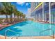 Resort-style pool surrounded by palm trees and lounge chairs for relaxation at 6804 N Ocean Blvd. # 523, Myrtle Beach, SC 29572