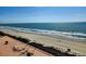 Scenic ocean view from a high balcony, showcasing the beach, clear skies, and sparkling water at 6900 N Ocean Blvd. # 1034, Myrtle Beach, SC 29579