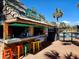 Charming poolside bar with vibrant stools and a thatched roof, perfect for refreshments at 6900 N Ocean Blvd. # 1034, Myrtle Beach, SC 29579