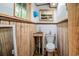 Quaint bathroom featuring wood-paneled walls, a compact sink, toilet, and charming artwork displayed above at 70 Izard Pl., Georgetown, SC 29440