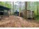 Cluster of rustic cabins nestled among tall trees, showing exterior details and natural surroundings at 70 Izard Pl., Georgetown, SC 29440