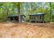 Quaint cabin with multiple buildings surrounded by lush trees and a serene setting at 70 Izard Pl., Georgetown, SC 29440