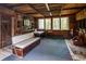 Rustic living room with wood-paneled walls, large windows, and simple furniture adding to the charm at 70 Izard Pl., Georgetown, SC 29440
