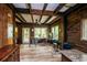 Rustic living room featuring wood walls, ceilings, a ceiling fan, and scenic outdoor views from large windows at 70 Izard Pl., Georgetown, SC 29440