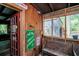 Enclosed porch with rustic decor, bench seating, and vintage signs adding character to the space at 70 Izard Pl., Georgetown, SC 29440