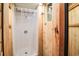Simple shower with a plastic curtain, wooden walls, and a small window adding natural light at 70 Izard Pl., Georgetown, SC 29440