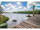 Scenic waterfront view with a weathered wooden pier, clear water and lush green trees in the background at 70 Izard Pl., Georgetown, SC 29440