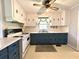 Functional kitchen with white cabinetry, blue accents, and updated appliances at 701 Martin Luther King Dr., Andrews, SC 29510