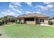 A spacious backyard featuring lush green grass and a screened-in porch area at 7041 Turtle Cove Dr., Myrtle Beach, SC 29579