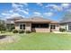 A well-kept backyard featuring lush green grass and a screened-in porch area at 7041 Turtle Cove Dr., Myrtle Beach, SC 29579