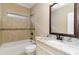 Bathroom featuring granite counters, tiled shower, and ample natural light at 7041 Turtle Cove Dr., Myrtle Beach, SC 29579