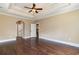A room with hardwood floors, three entryways and a decorative tray ceiling at 7041 Turtle Cove Dr., Myrtle Beach, SC 29579