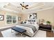 A primary bedroom with a tray ceiling, ceiling fan, and two bedside tables at 7041 Turtle Cove Dr., Myrtle Beach, SC 29579