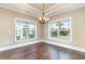 Dining Room with hardwood floors, chandelier and two windows offering a view at 7041 Turtle Cove Dr., Myrtle Beach, SC 29579