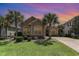Charming single-story home with well-manicured lawn, vibrant landscaping, and mature palm trees at 7041 Turtle Cove Dr., Myrtle Beach, SC 29579