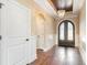 Elegant foyer with hardwood floors, decorative ceiling, chandelier, and arched doorway at 7041 Turtle Cove Dr., Myrtle Beach, SC 29579