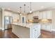 Gourmet kitchen featuring a large island, granite countertops, stainless steel appliances, and custom cabinetry at 7041 Turtle Cove Dr., Myrtle Beach, SC 29579