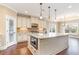 A kitchen featuring granite countertops, a kitchen island with stainless steel microwave, and hardwood floors at 7041 Turtle Cove Dr., Myrtle Beach, SC 29579