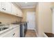 Laundry room features granite countertop, cabinetry, and a gray washer and dryer at 7041 Turtle Cove Dr., Myrtle Beach, SC 29579