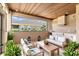 Outdoor lounge area with wood ceiling, couches, chairs, and exterior kitchen at 7041 Turtle Cove Dr., Myrtle Beach, SC 29579
