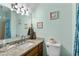 Bathroom with a granite countertop, shell decor, and a shower with a blue curtain at 707 S 26Th Ave. S # L, North Myrtle Beach, SC 29582