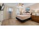Bedroom featuring a king bed, wood floors, a ceiling fan, and natural light at 707 S 26Th Ave. S # L, North Myrtle Beach, SC 29582
